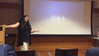 Presenter pointing at slideshow on screen